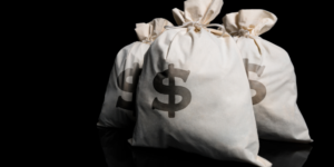 Three white fabric sacks marked with a dollar sign against a black background, signifying putting extra into super