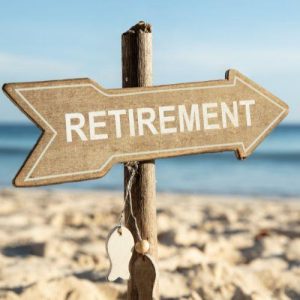 A wooden sign is pegged into the beach with the word 'retirement' on it. Knowing the rules about what is considered 'retirement' will allow you to understand when you can access your super.