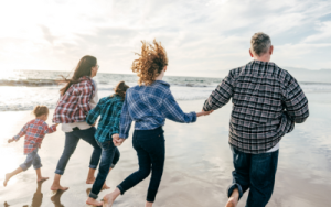 family running on beach