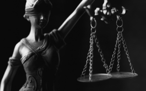 A blindfolded statue holds up a pair of scales. Indicating a court or 'justice'. A court may need to decide how super will be split in family law